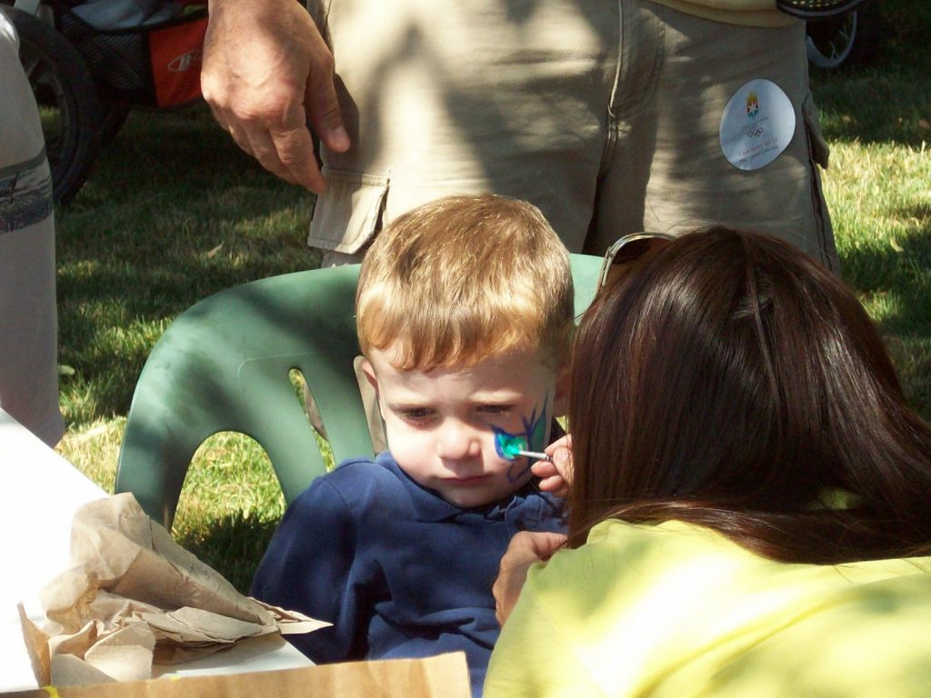 Kid getting face painting at Jonquil Park